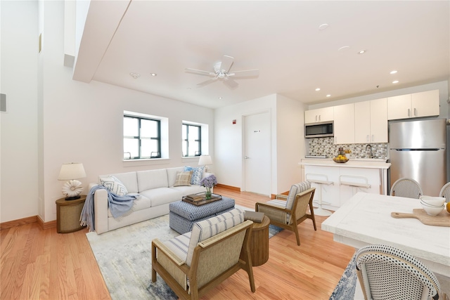 70 S Main St Unit 307-Ph, Freeport, NY 11520 - living room with light wood finished floors, ceiling fan, baseboards, and recessed lighting