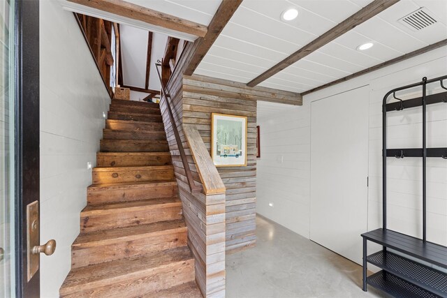3 Pheasant Ln, Remsenburg, NY 11960 - staircase featuring concrete flooring, wood walls, beamed ceiling, and recessed lighting