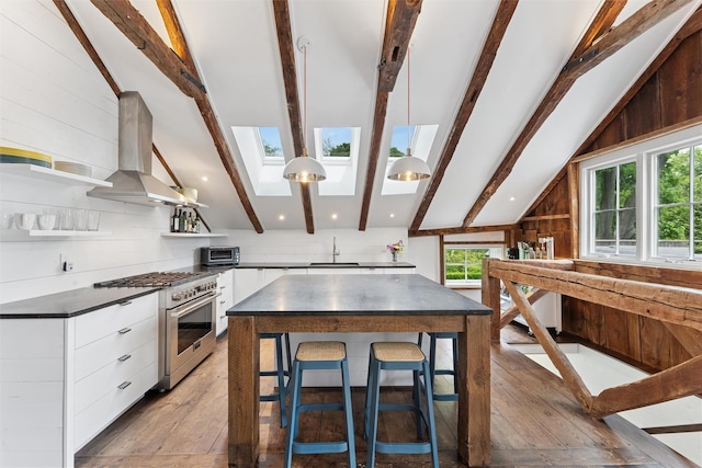 3 Pheasant Ln, Remsenburg, NY 11960 - kitchen featuring high end stainless steel range, a skylight, dark countertops, white cabinets, and modern cabinets