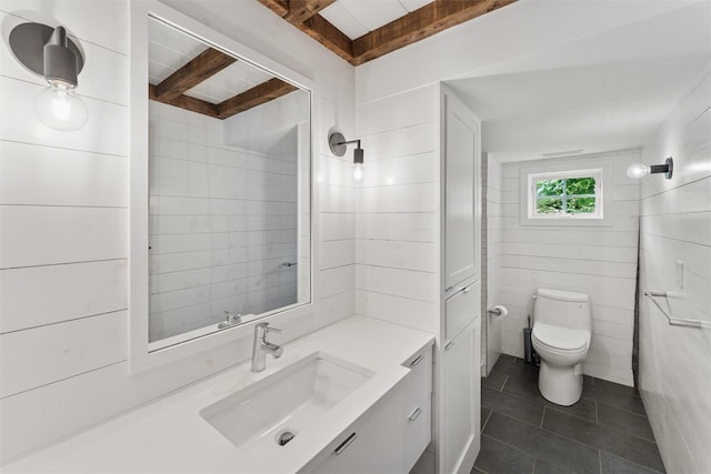 3 Pheasant Ln, Remsenburg, NY 11960 - bathroom featuring tile patterned floors, beam ceiling, vanity, and toilet