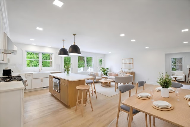 2 Crawford Rd, Harrison, NY 10528 - kitchen with a center island, a sink, stainless steel microwave, open floor plan, and recessed lighting
