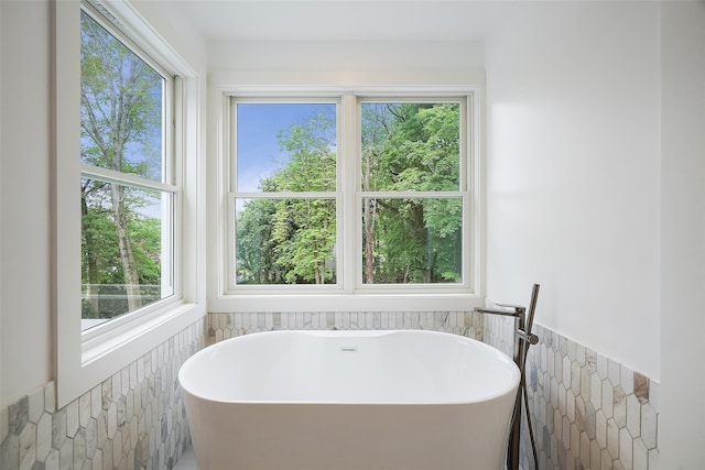 2 Crawford Rd, Harrison, NY 10528 - full bath featuring a wainscoted wall, healthy amount of natural light, a soaking tub, and tile walls