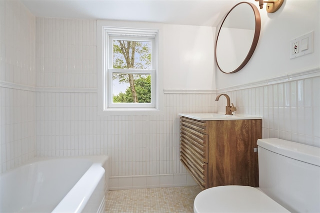 2 Crawford Rd, Harrison, NY 10528 - bathroom featuring tile walls, toilet, a bath, tile patterned floors, and vanity