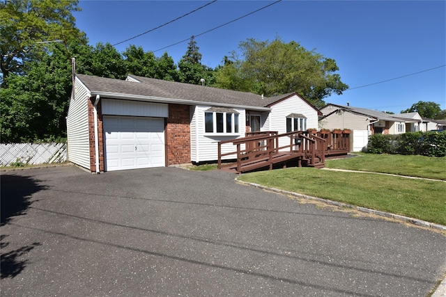 324 W 16th St, Deer Park, NY 11729 - ranch-style home with brick siding, driveway, an attached garage, a deck, and roof with shingles