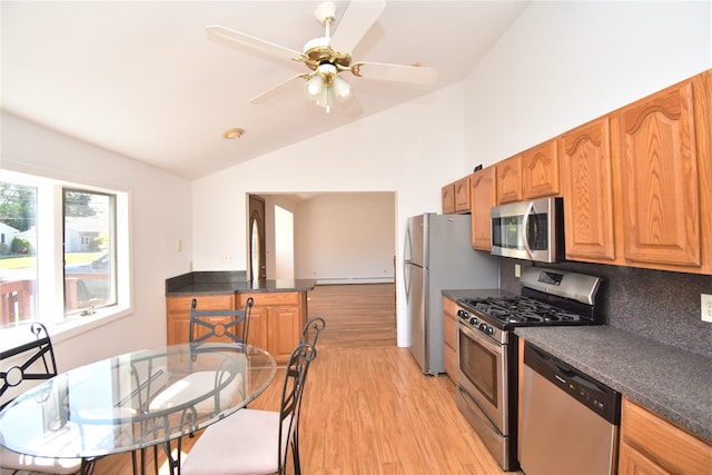 324 W 16th St, Deer Park, NY 11729 - kitchen featuring stainless steel appliances, lofted ceiling, light wood-style floors, dark countertops, and a ceiling fan