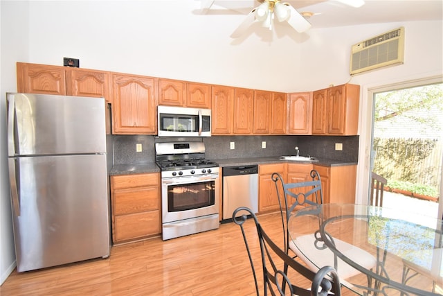 324 W 16th St, Deer Park, NY 11729 - kitchen featuring stainless steel appliances, a wall mounted air conditioner, a sink, dark countertops, and a towering ceiling