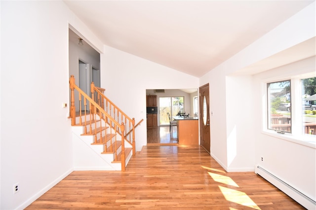 324 W 16th St, Deer Park, NY 11729 - foyer with a baseboard radiator, plenty of natural light, light wood finished floors, stairs, and lofted ceiling