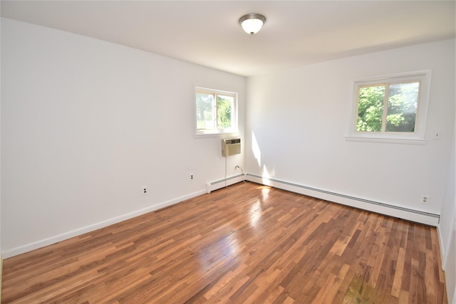 324 W 16th St, Deer Park, NY 11729 - unfurnished room featuring wood finished floors, a baseboard radiator, a wall unit AC, baseboards, and a baseboard heating unit