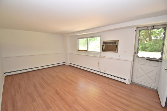 324 W 16th St, Deer Park, NY 11729 - spare room featuring a baseboard radiator, light wood-style flooring, and an AC wall unit