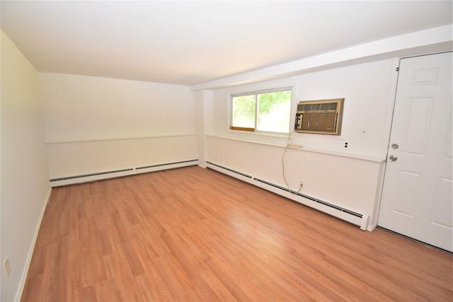 324 W 16th St, Deer Park, NY 11729 - spare room with baseboard heating, light wood-style floors, and an AC wall unit