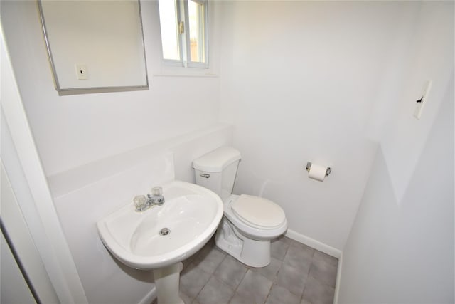 324 W 16th St, Deer Park, NY 11729 - half bathroom with toilet, tile patterned floors, a sink, and baseboards