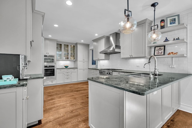 9 Springdale Rd, Scarsdale, NY 10583 - kitchen featuring wall chimney range hood, a sink, a peninsula, open shelves, and decorative backsplash