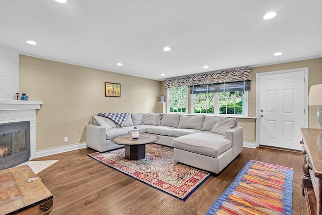 9 Springdale Rd, Scarsdale, NY 10583 - living room with dark wood-type flooring, a brick fireplace, recessed lighting, baseboards, and crown molding