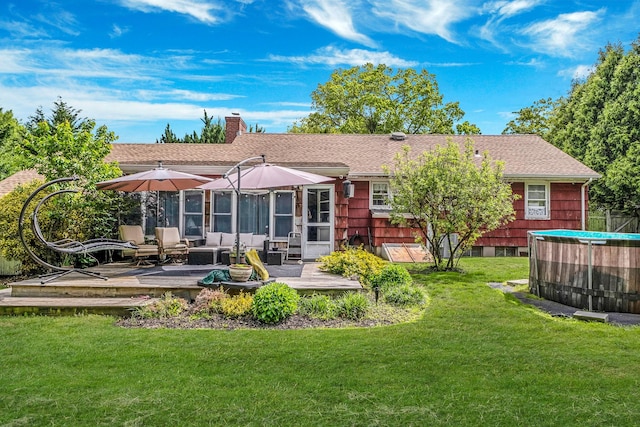 891 Pondview Rd, Riverhead, NY 11901 - rear view of house with a deck, a chimney, a yard, an outdoor hangout area, and a shingled roof