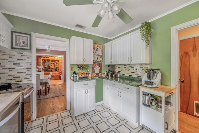 891 Pondview Rd, Riverhead, NY 11901 - kitchen with a ceiling fan, white cabinetry, light flooring, stainless steel electric stove, and tasteful backsplash