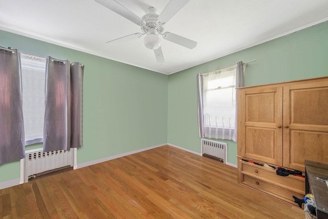 891 Pondview Rd, Riverhead, NY 11901 - unfurnished bedroom featuring radiator heating unit, wood finished floors, and baseboards
