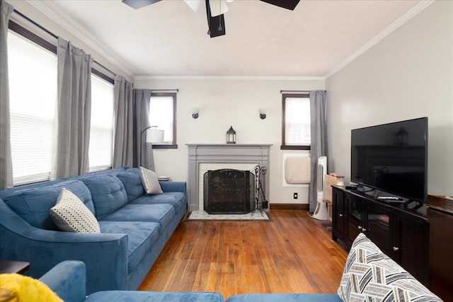 139 Euston Rd S, West Hempstead, NY 11552 - living room featuring a ceiling fan, wood finished floors, crown molding, a fireplace, and baseboards