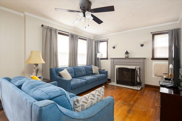 139 Euston Rd S, West Hempstead, NY 11552 - living room with hardwood / wood-style flooring, crown molding, a ceiling fan, baseboards, and a fireplace