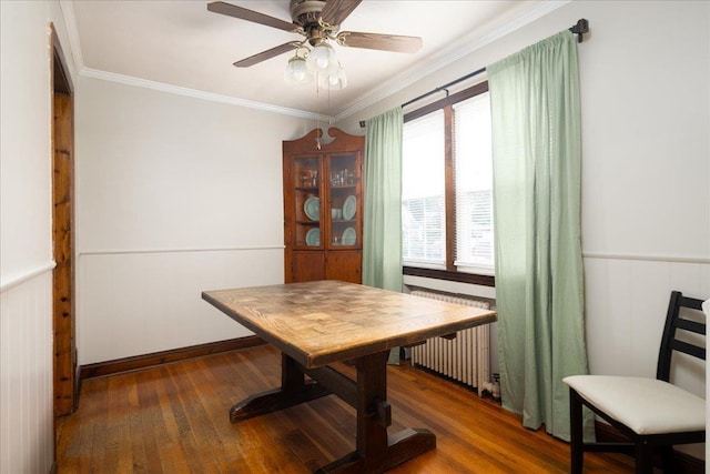 139 Euston Rd S, West Hempstead, NY 11552 - dining space with hardwood / wood-style flooring, a wainscoted wall, radiator heating unit, a ceiling fan, and crown molding