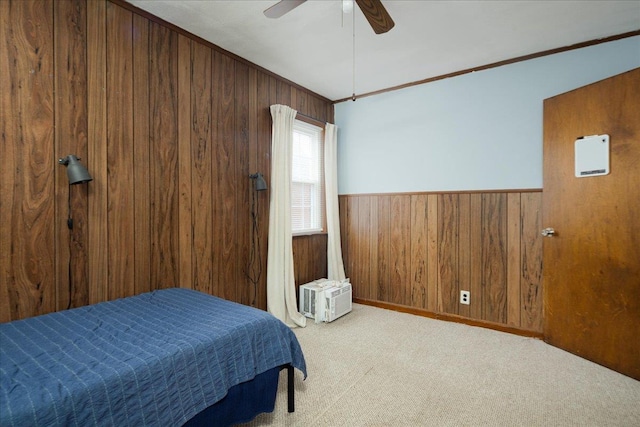 139 Euston Rd S, West Hempstead, NY 11552 - carpeted bedroom featuring wooden walls, ornamental molding, a wainscoted wall, and a ceiling fan