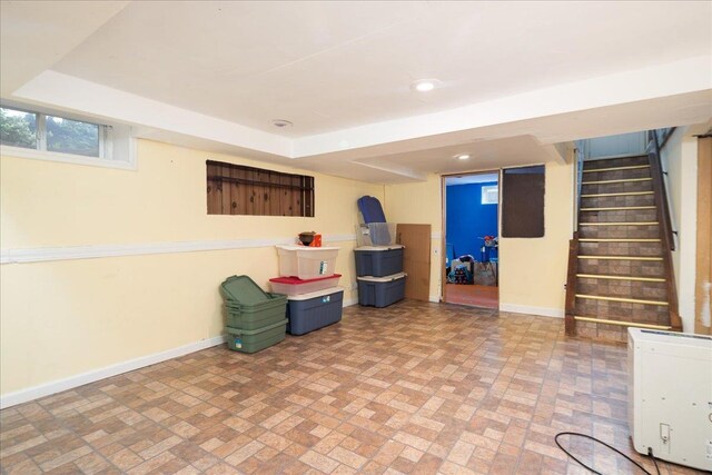 139 Euston Rd S, West Hempstead, NY 11552 - below grade area with brick patterned floors, baseboards, stairway, and recessed lighting