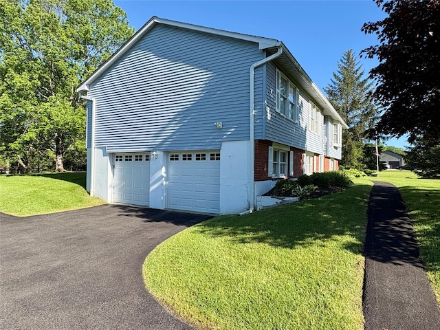 25 White Farm Rd, Wingdale, NY 12594 - view of side of property featuring asphalt driveway, a yard, a garage, and brick siding