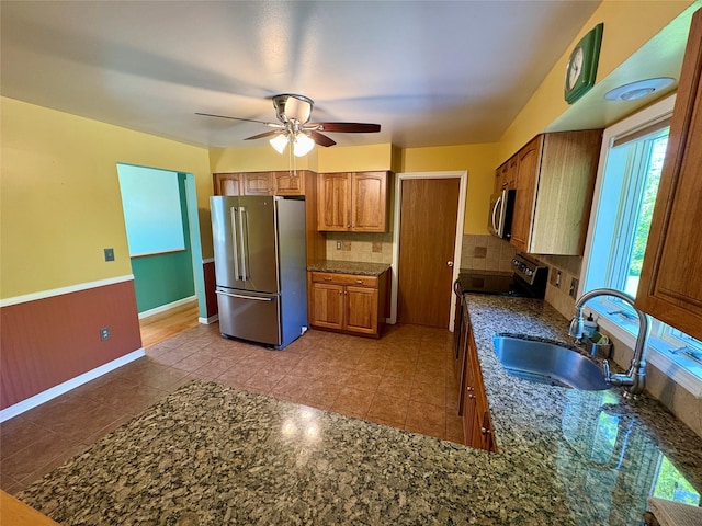 25 White Farm Rd, Wingdale, NY 12594 - kitchen with appliances with stainless steel finishes, a sink, brown cabinets, and healthy amount of natural light