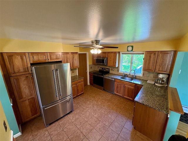 25 White Farm Rd, Wingdale, NY 12594 - kitchen featuring stainless steel appliances, a sink, brown cabinets, a ceiling fan, and backsplash