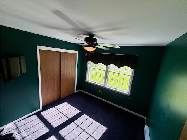 25 White Farm Rd, Wingdale, NY 12594 - unfurnished bedroom featuring dark colored carpet, a closet, ceiling fan, baseboards, and a baseboard heating unit