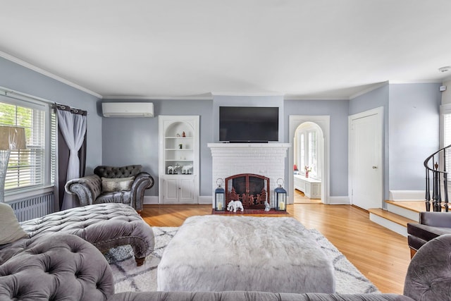 177 N Long Beach Ave, Freeport, NY 11520 - living area featuring a wall mounted air conditioner, ornamental molding, light wood finished floors, a fireplace, and radiator heating unit