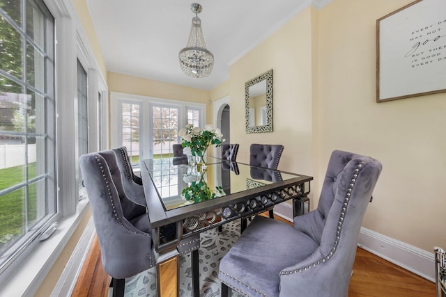 177 N Long Beach Ave, Freeport, NY 11520 - dining space featuring baseboards, a chandelier, wood finished floors, and ornamental molding