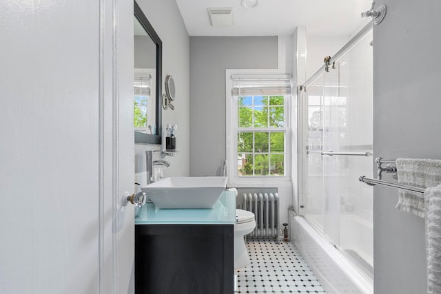 177 N Long Beach Ave, Freeport, NY 11520 - bathroom with radiator heating unit, toilet, healthy amount of natural light, and combined bath / shower with glass door