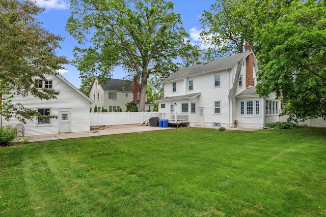 177 N Long Beach Ave, Freeport, NY 11520 - back of property with a patio, a deck, a shingled roof, and a chimney