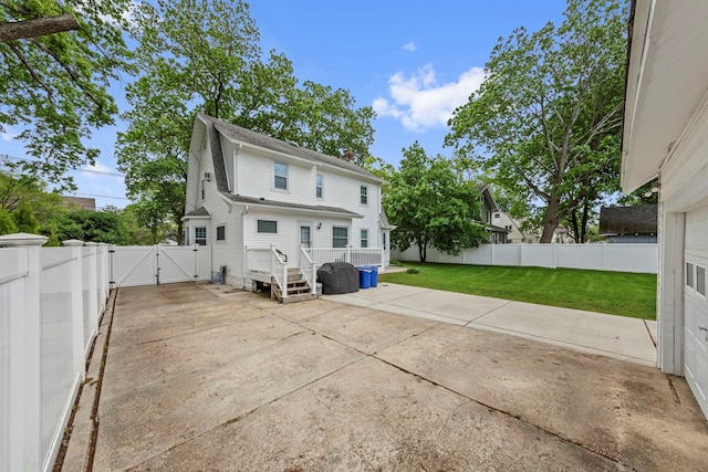 177 N Long Beach Ave, Freeport, NY 11520 - rear view of house featuring a gate, a patio area, and a chimney