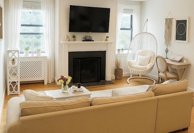 68 E Hartsdale Ave Unit 5E, Hartsdale, NY 10530 - living area with wood finished floors and a fireplace with flush hearth