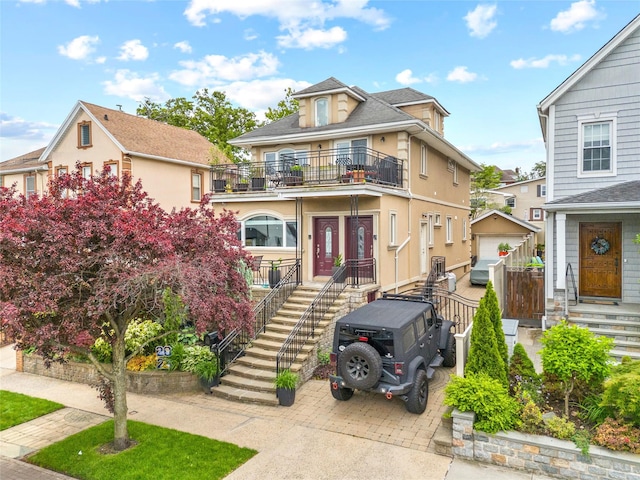 154-16 13th Ave, Whitestone, NY 11357 - view of front of property featuring a balcony, stairway, and stucco siding