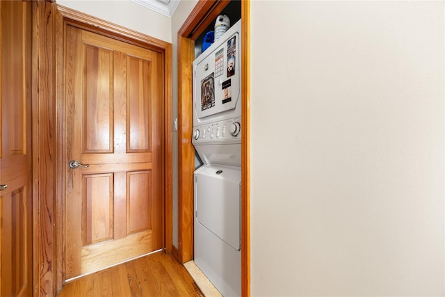154-16 13th Ave, Whitestone, NY 11357 - laundry area featuring stacked washer / drying machine, light wood-type flooring, and crown molding