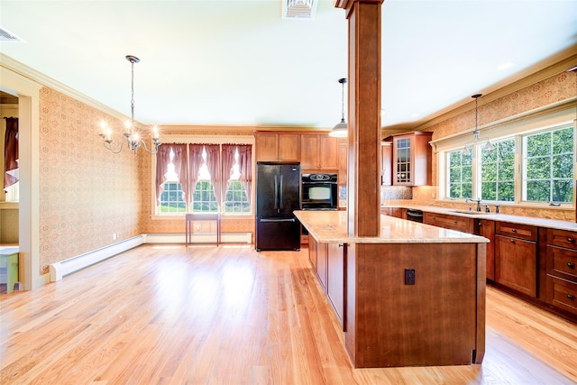 231 Turtle Bay Rd, New Hampton, NY 10958 - kitchen with black appliances, a baseboard heating unit, wallpapered walls, a kitchen island, and light wood finished floors