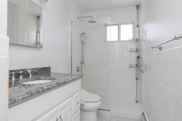 563 Long Beach Rd, Island Park, NY 11558 - full bathroom featuring a tile shower, vanity, tile walls, toilet, and marble finish floors