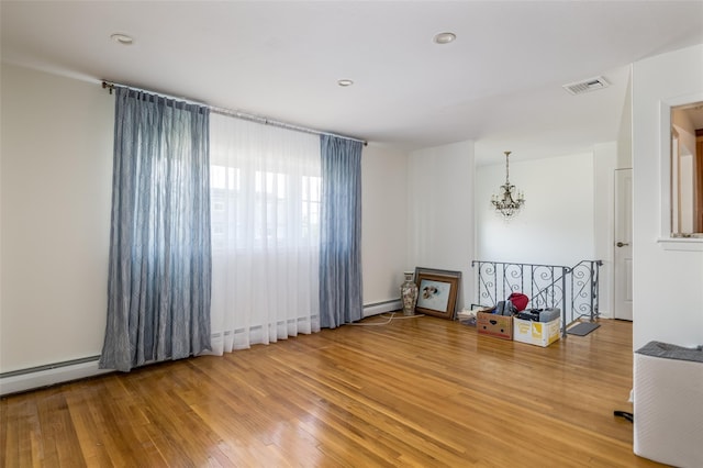 563 Long Beach Rd, Island Park, NY 11558 - empty room featuring light wood finished floors, a chandelier, a baseboard radiator, and recessed lighting
