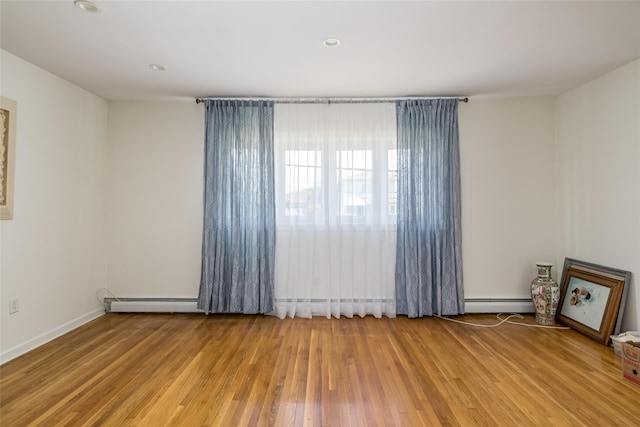 563 Long Beach Rd, Island Park, NY 11558 - spare room featuring a baseboard heating unit, wood finished floors, and recessed lighting
