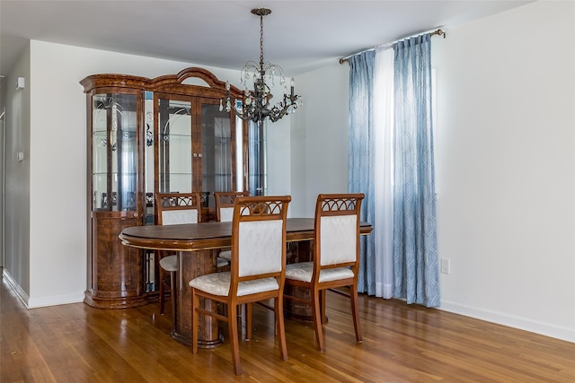 563 Long Beach Rd, Island Park, NY 11558 - dining room with a chandelier, wood finished floors, and baseboards