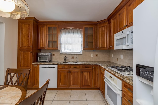 563 Long Beach Rd, Island Park, NY 11558 - kitchen featuring white appliances, a sink, brown cabinets, and tasteful backsplash