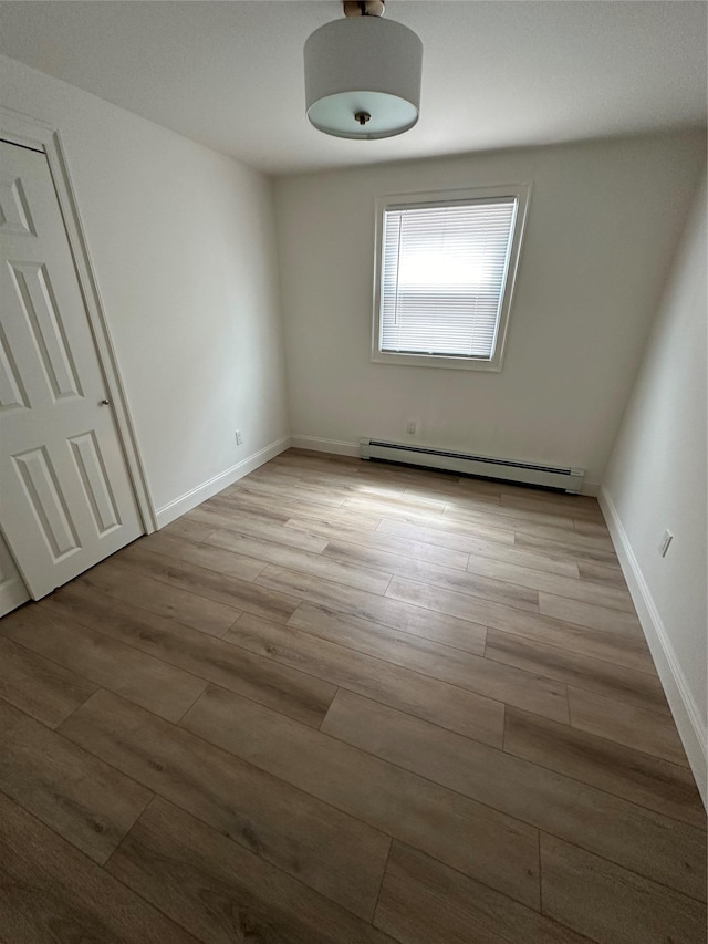 563 Long Beach Rd, Island Park, NY 11558 - spare room featuring baseboard heating and wood finished floors