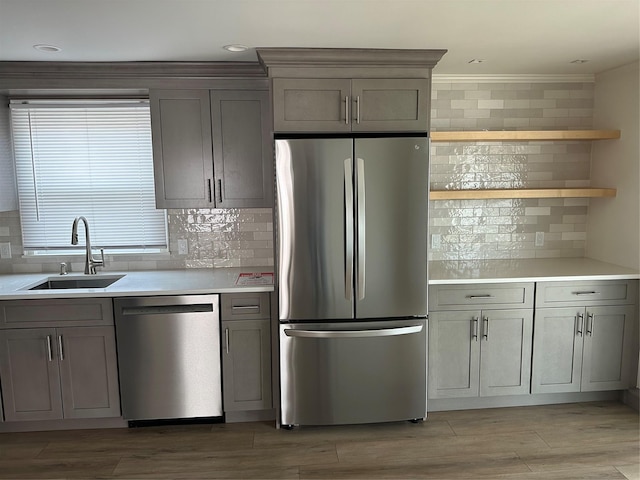 563 Long Beach Rd, Island Park, NY 11558 - kitchen with appliances with stainless steel finishes, tasteful backsplash, gray cabinets, light countertops, and crown molding