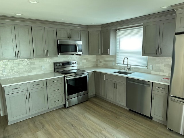 563 Long Beach Rd, Island Park, NY 11558 - kitchen featuring stainless steel appliances, decorative backsplash, light countertops, light wood-style floors, and recessed lighting