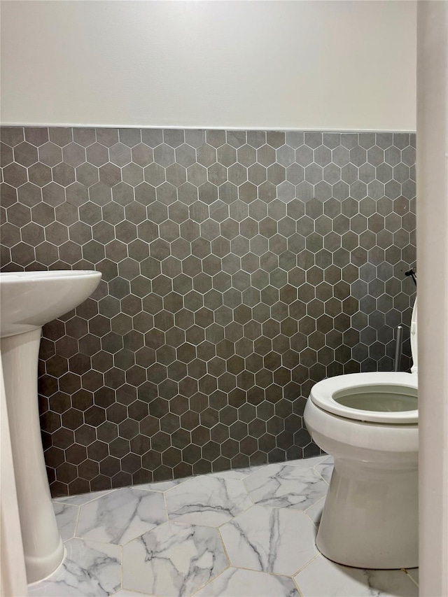 2337 Sycamore Ave, Ronkonkoma, NY 11779 - bathroom featuring tile walls, marble finish flooring, and toilet