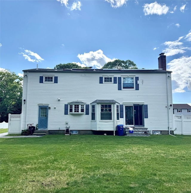 2337 Sycamore Ave, Ronkonkoma, NY 11779 - back of house with entry steps and a chimney