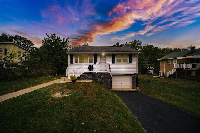 26 Booth Blvd, Wappingers Falls, NY 12590 - ranch-style home with stairway, a porch, driveway, a front yard, and a garage