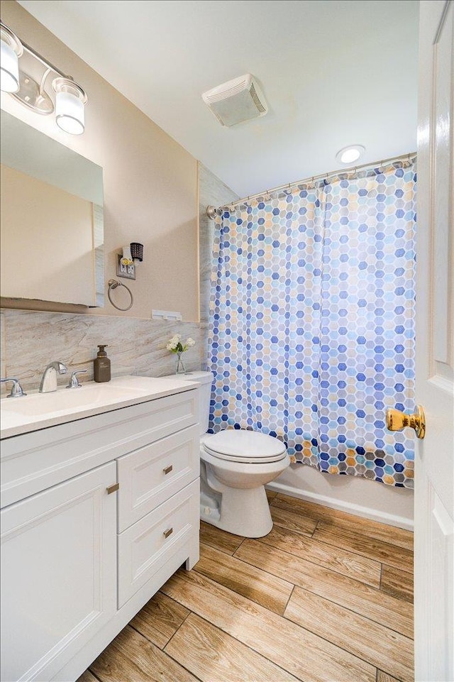26 Booth Blvd, Wappingers Falls, NY 12590 - full bathroom with vanity, toilet, wood finished floors, shower / bath combination with curtain, and decorative backsplash